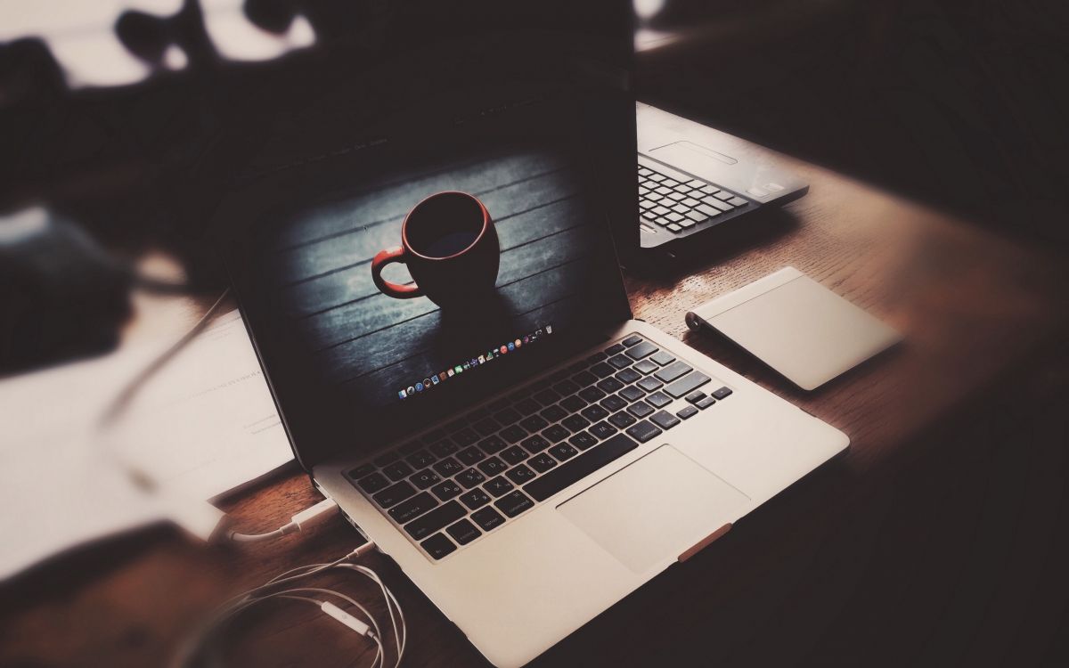 macbook pro on brown wooden table