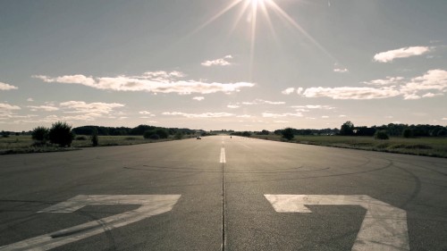 Image gray concrete road under white clouds during daytime