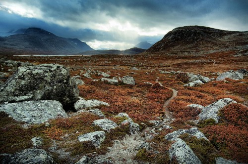 Image brown and gray rocky mountain under white cloudy sky during daytime