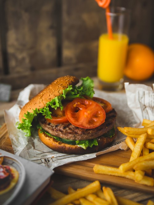 Image burger with lettuce and tomato on white paper