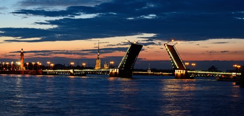 Image city skyline across body of water during sunset