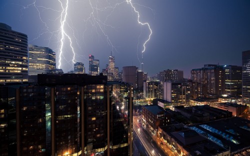 Image lightning over city buildings during night time