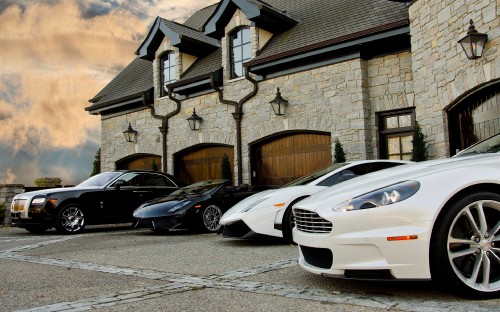 Image white porsche 911 parked beside brown brick building