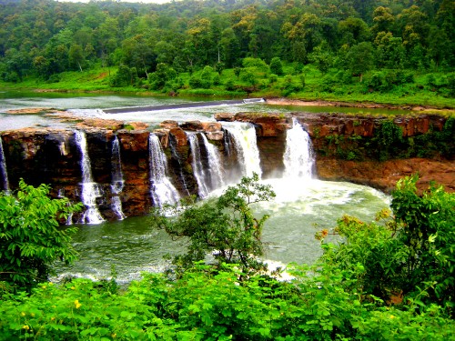 Image waterfalls in the middle of green grass field