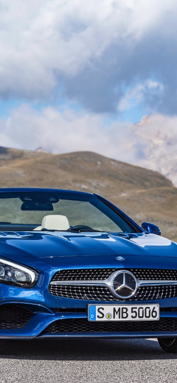 Image blue bmw m 3 on brown field under white clouds and blue sky during daytime