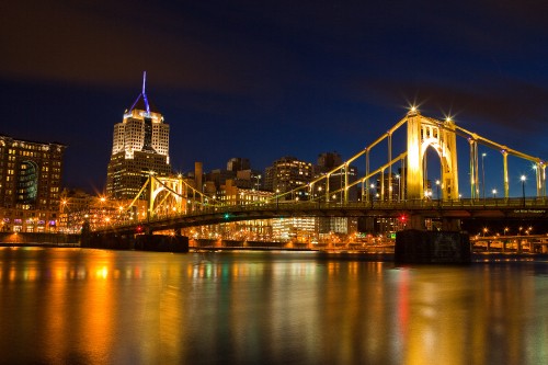 Image lighted bridge over water during night time