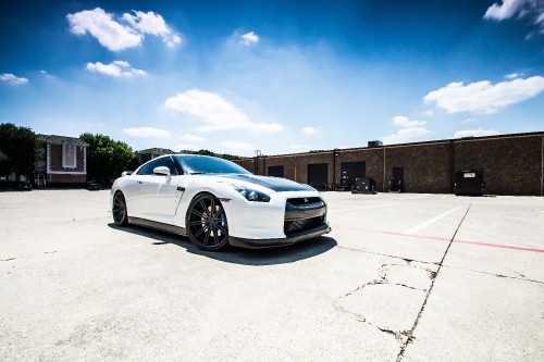 Image white coupe parked on gray concrete floor during daytime