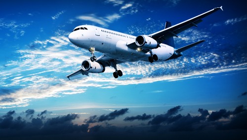 Image white and blue airplane under blue sky during daytime