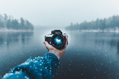 Image person holding black dslr camera