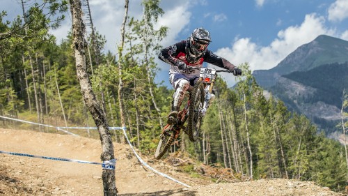 Image man in black and red jacket riding motocross dirt bike