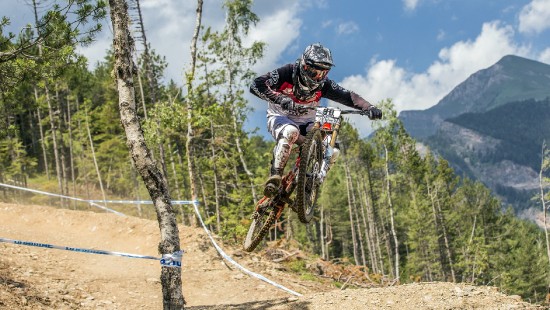 Image man in black and red jacket riding motocross dirt bike