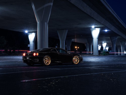 Image black sports car on road during night time