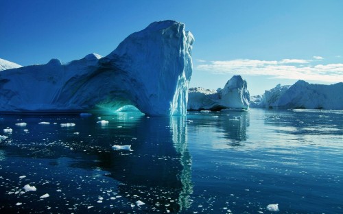 Image white ice on body of water near mountain during daytime