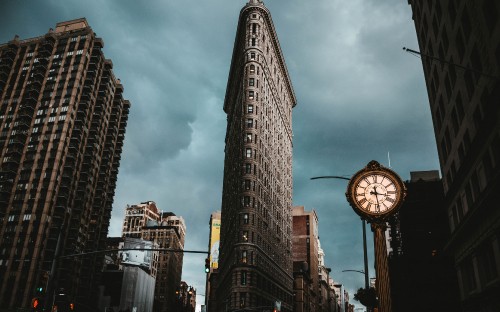 Image gray concrete building under cloudy sky during daytime