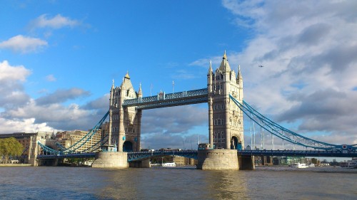 Image gray concrete bridge under blue sky during daytime