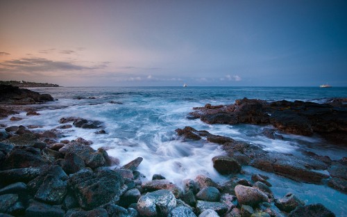 Image rocky shore with sea waves crashing on shore during daytime