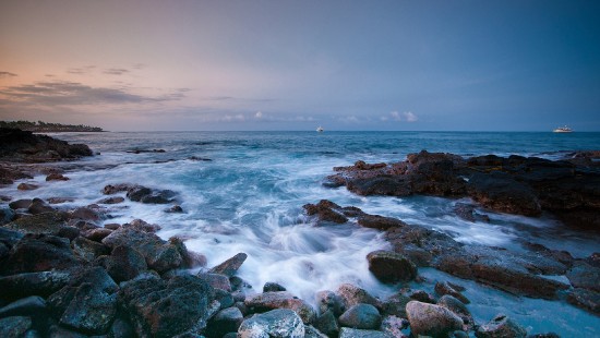 Image rocky shore with sea waves crashing on shore during daytime