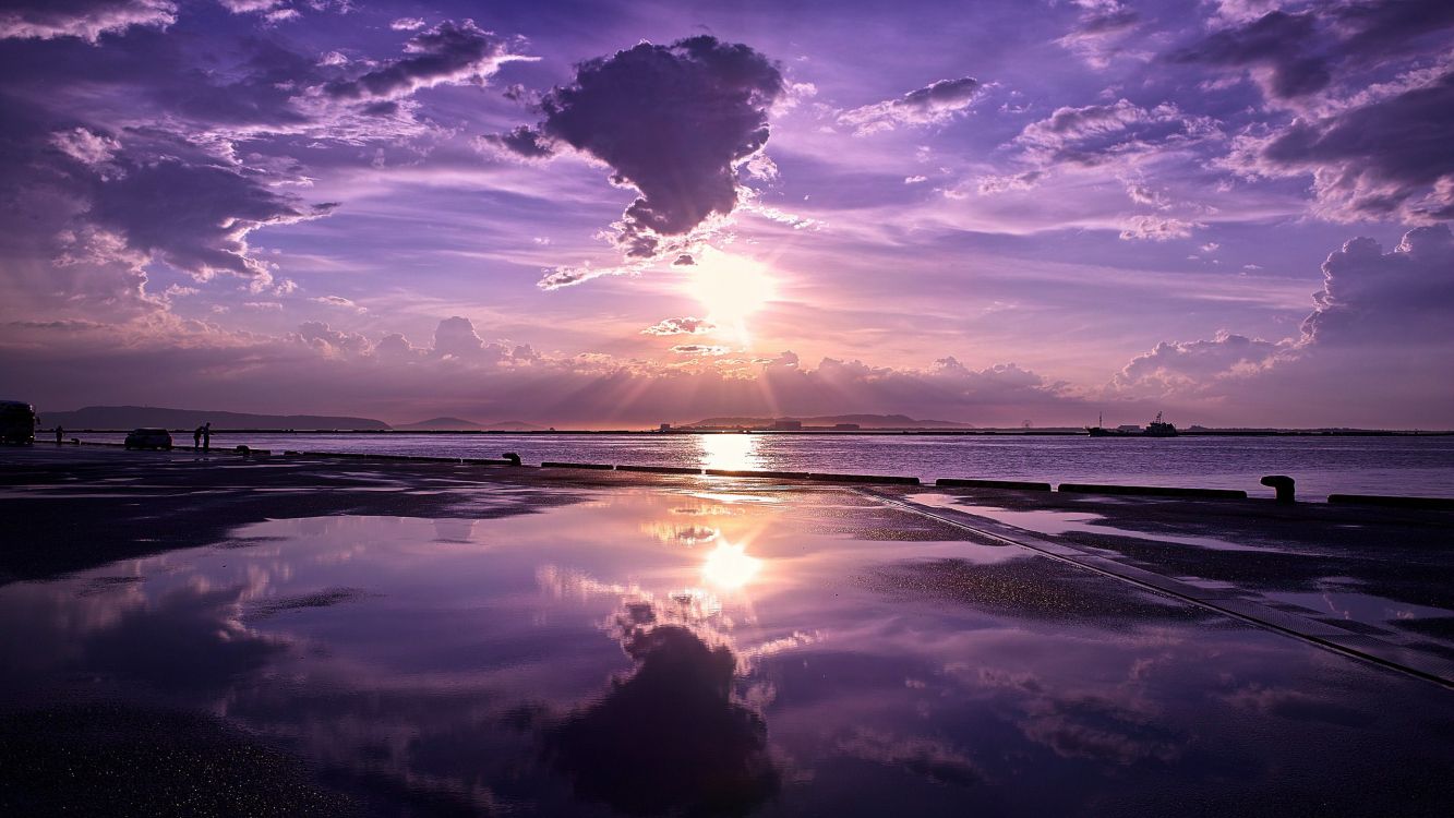 body of water under blue sky during sunset