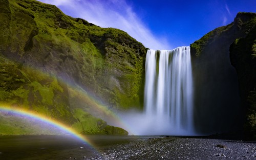 Image waterfalls on gray rocky mountain under blue sky during daytime