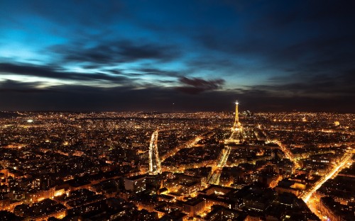 Image city skyline under blue sky during night time