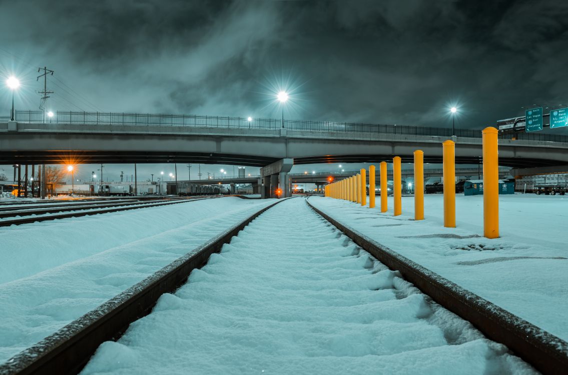 snow covered bridge during night time