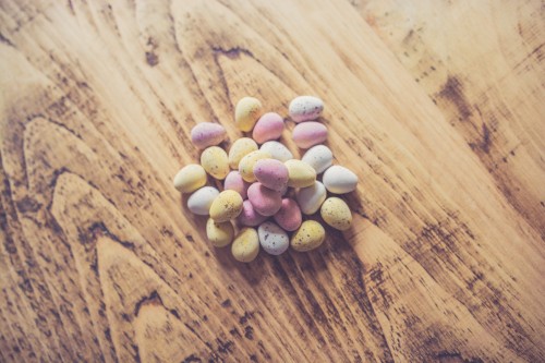 Image pink and white heart shaped candies on brown wooden table