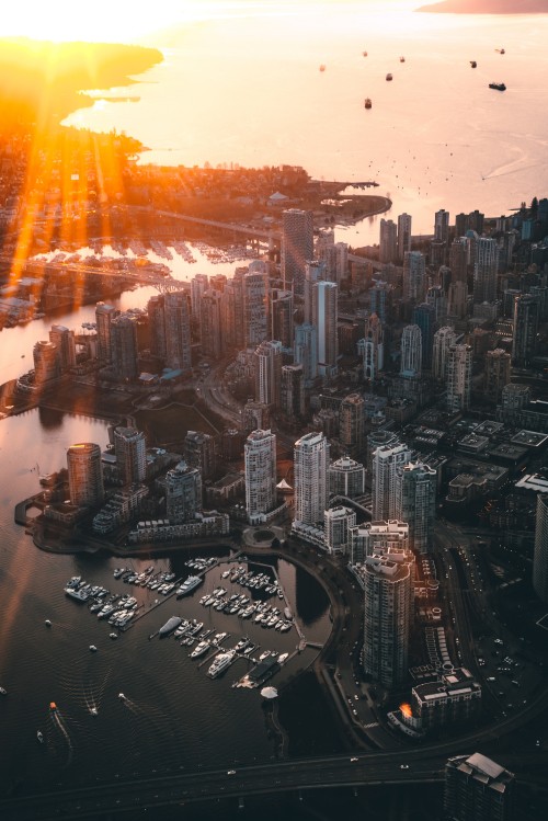 Image aerial view of city buildings during sunset