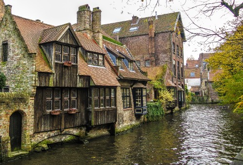 Image brown brick building beside river during daytime