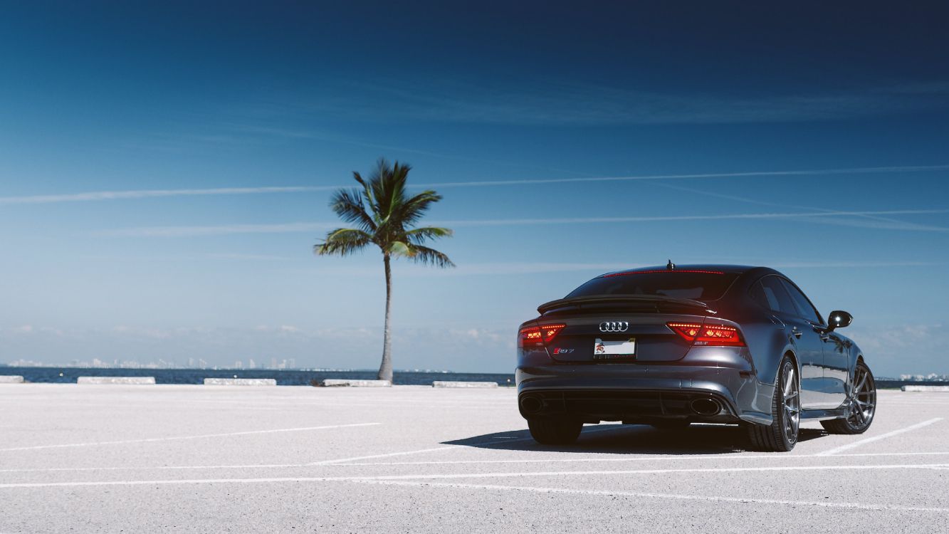 red car on white sand during daytime