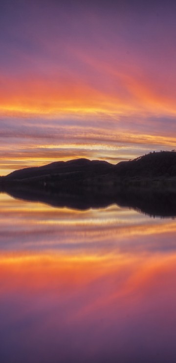 Image body of water near mountain during sunset