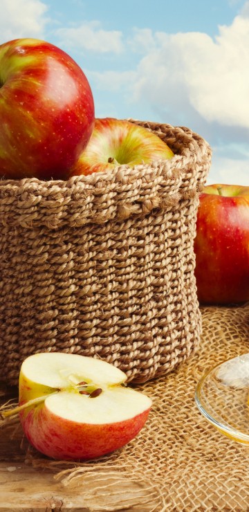 Image red apples on brown woven basket