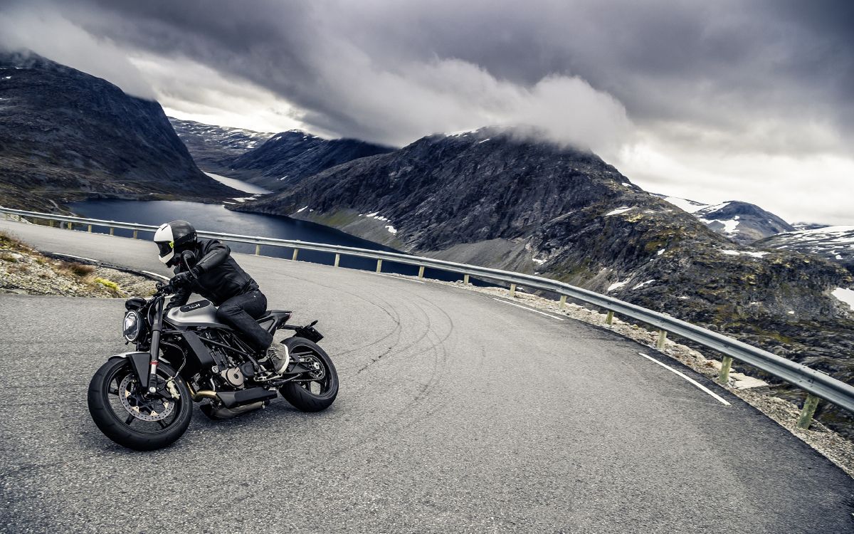 black motorcycle on road near mountain during daytime