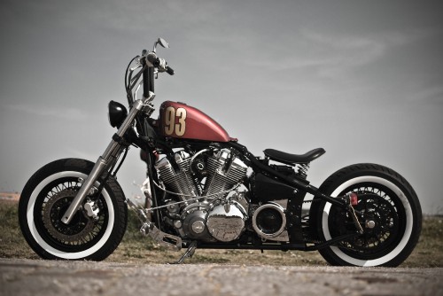 Image red and black motorcycle on brown field