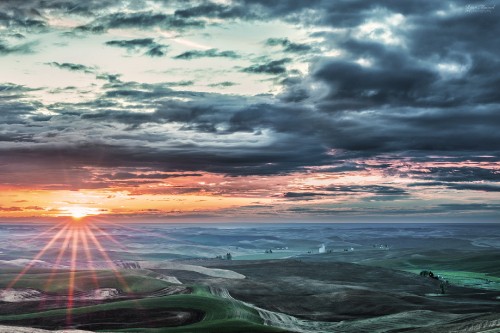 Image green grass field near sea under cloudy sky during sunset