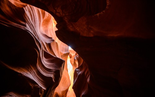 Image brown and white cave with brown and black rock formation