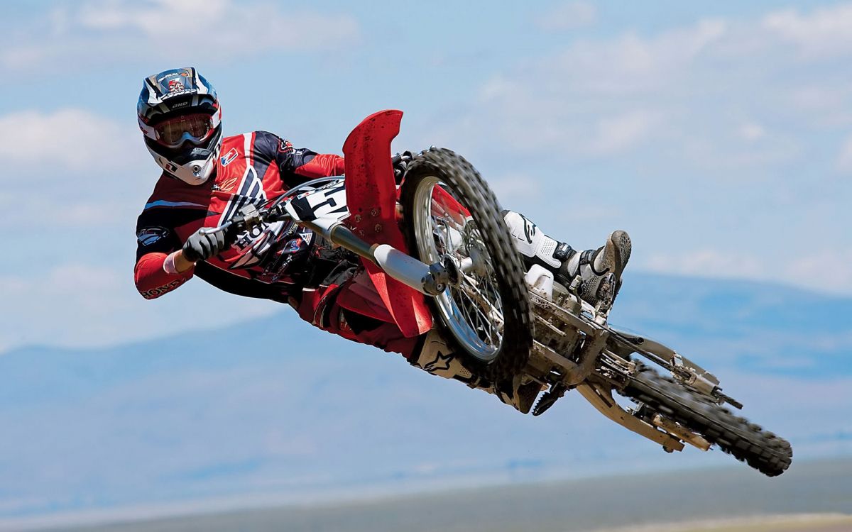 Man in Red and Black Motocross Suit Riding Motocross Dirt Bike. Wallpaper in 1920x1200 Resolution