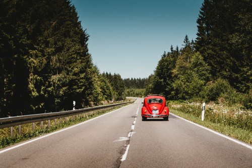 Image red car on road during daytime