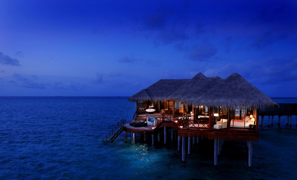 brown wooden dock on blue sea under blue sky during daytime