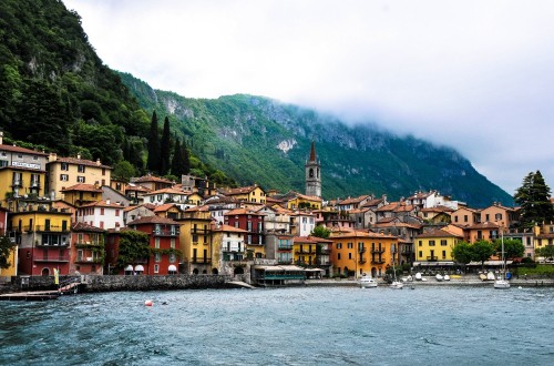 Image brown and white concrete buildings near body of water during daytime