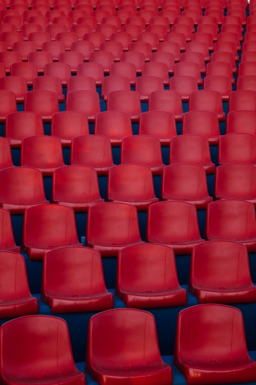 Image red plastic chairs in stadium