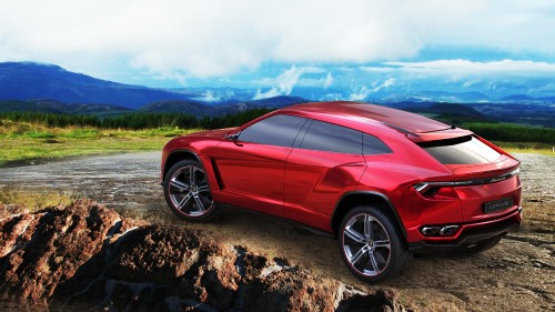 Image red ferrari 458 italia on brown rocky field under blue and white cloudy sky